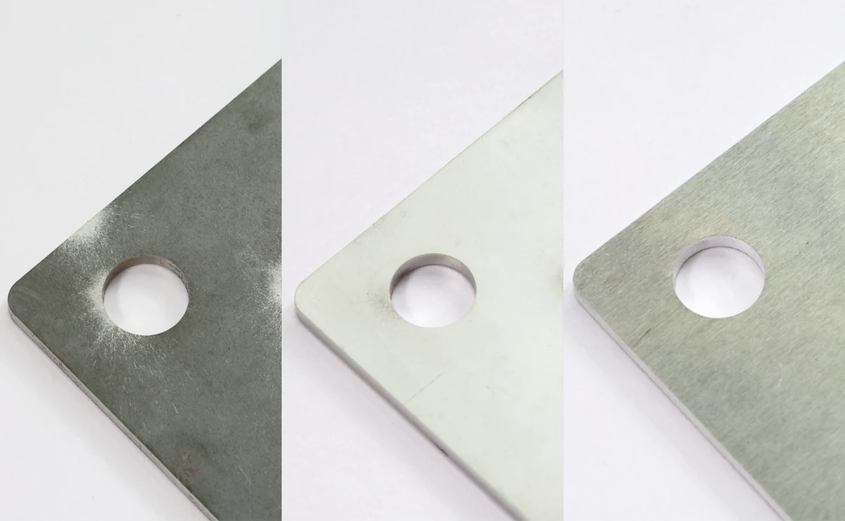 Laser cut holes in carbon steel, stainless steel and aluminum sheet shown side by side