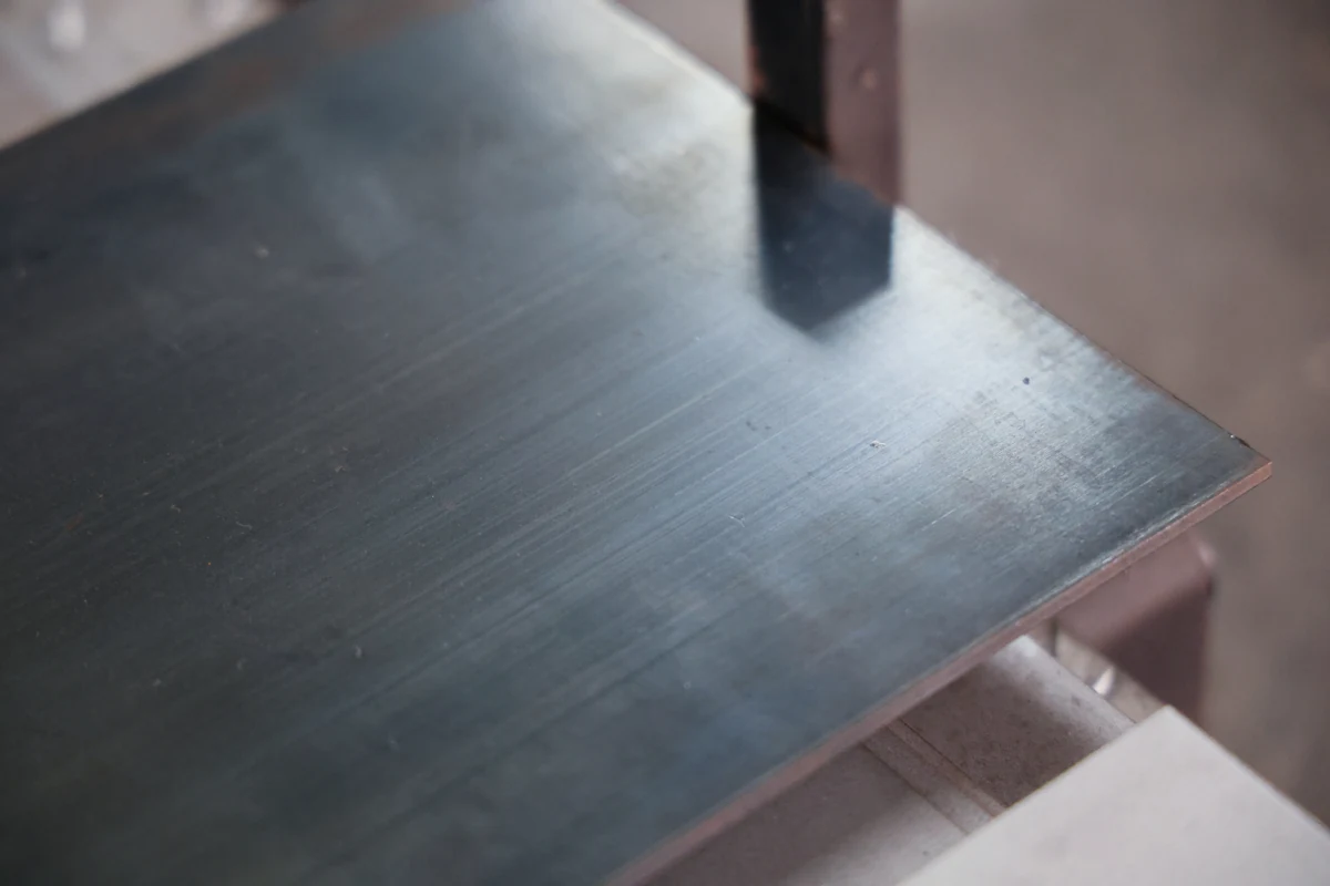 65Mn spring steel sheet stock at Boda, showing the blued surface finish of hardened, tempered material